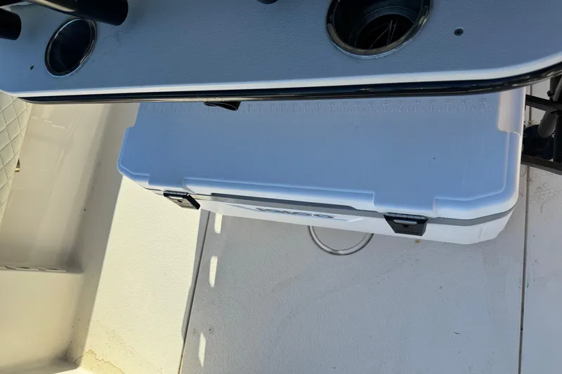 Slide: The Image of 2021 Sea Chaser 26LX boat interior with cooler and rod holders. - 37