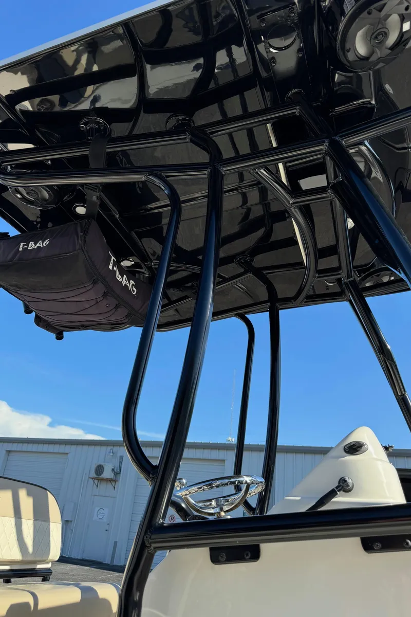 Slide: The Image of 2021 Sea Chaser 26LX boat with T-top and storage bag, under clear blue sky. - 40