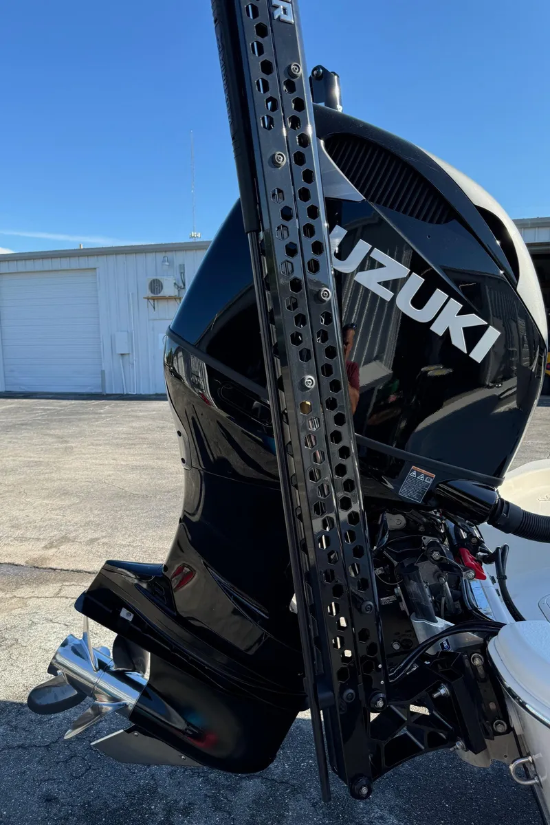 Slide: The Image of 2021 Sea Chaser 26LX with Suzuki outboard motor in a marina setting. - 42