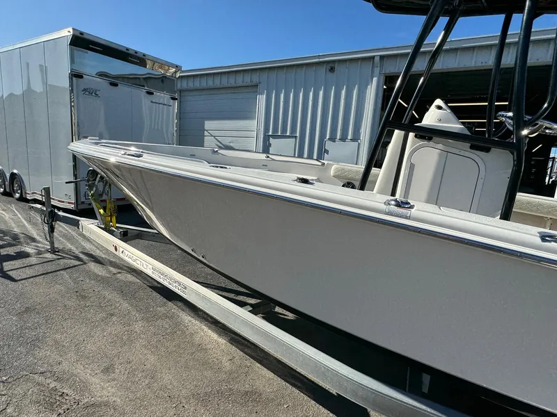 Slide: The Image of 2021 Sea Chaser 26LX boat on trailer, parked near a storage facility. - 5