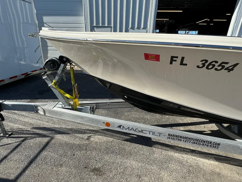 Slide: The Image of 2021 Sea Chaser 26LX boat on Magic Tilt trailer, parked outside a warehouse. - 6