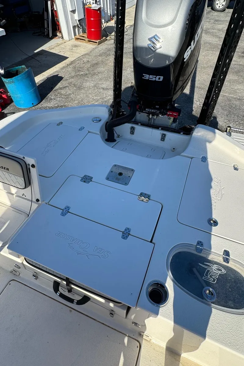 Slide: The Image of 2021 Sea Chaser 26LX boat with Suzuki 350 engine, featuring spacious deck and storage compartments. - 7