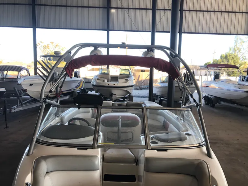 Slide: The Image of 2004 Tigé 22I TYPE R boat in storage, surrounded by other boats. - 6