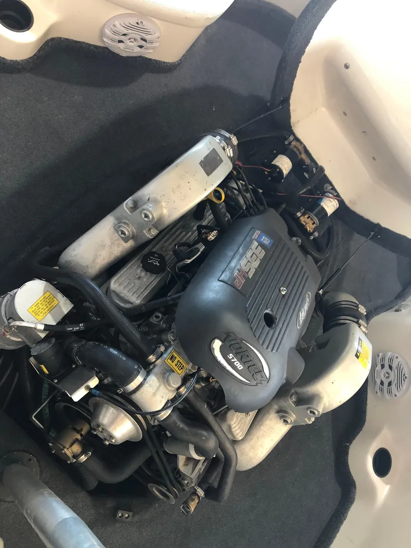 Slide: The Image of Engine compartment of a 2004 Tigé 22I TYPE R boat, showcasing the motor components. - 9