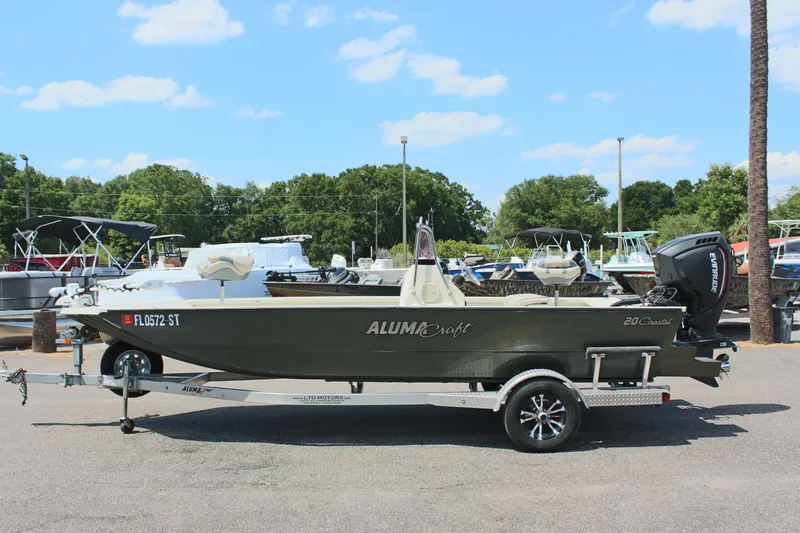 Slide: The Image of 2020 Alumacraft 20 Coastal Bay boat on trailer, parked outdoors under a clear sky. - 0