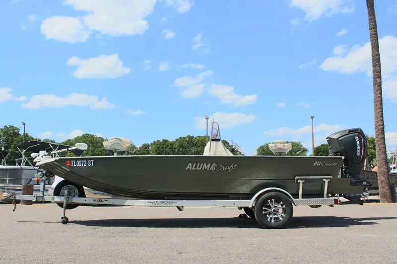 Slide: The Image of 2020 Alumacraft 20 Coastal Bay boat on trailer under blue sky. - 1