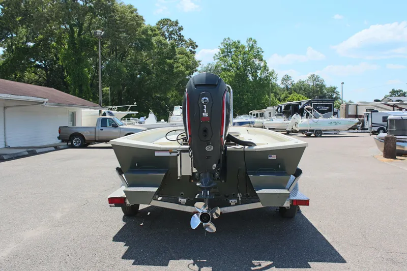 Slide: The Image of 2020 Alumacraft 20 Coastal Bay boat with outboard motor in a parking lot. - 10