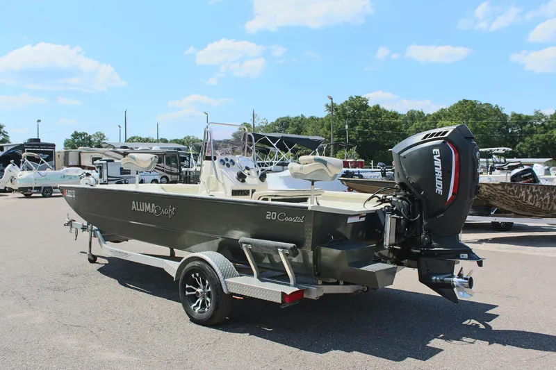Slide: The Image of 2020 Alumacraft 20 Coastal Bay boat on trailer, parked outdoors under blue sky. - 11