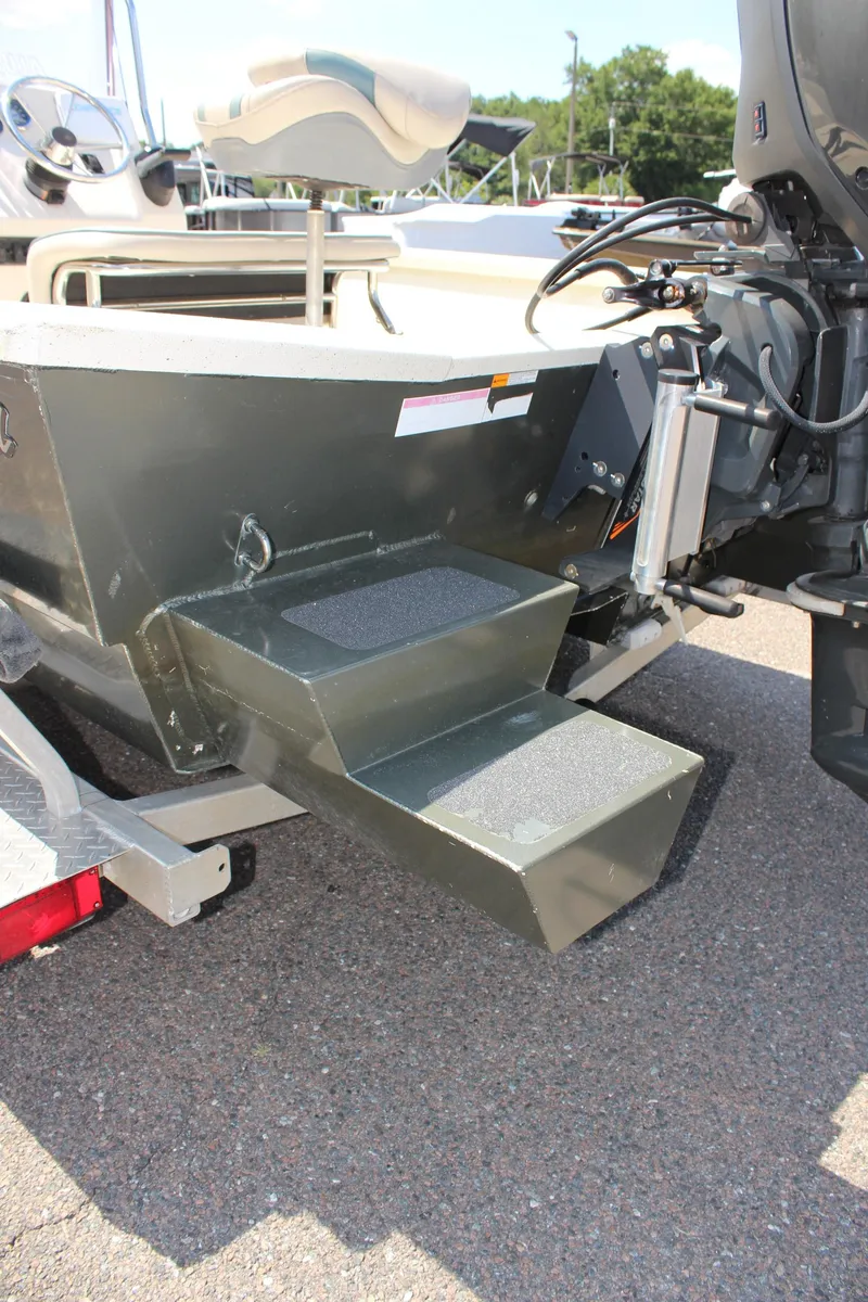 Slide: The Image of 2020 Alumacraft 20 Coastal Bay boat stern with motor and trailer. - 12