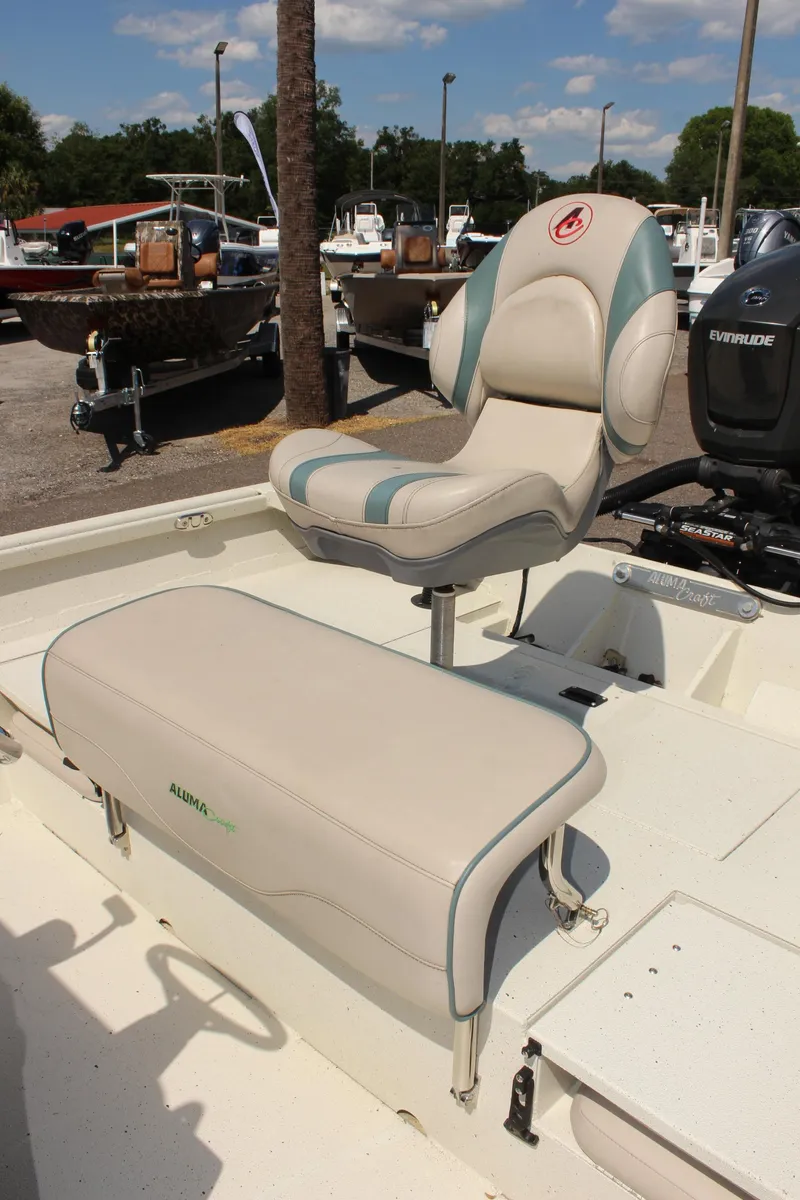 Slide: The Image of 2020 Alumacraft 20 Coastal Bay boat interior with seating and motor. - 13