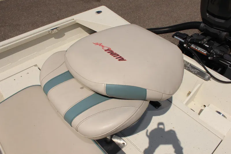 Slide: The Image of 2020 Alumacraft 20 Coastal Bay boat seat with logo, featuring beige and teal design. - 15