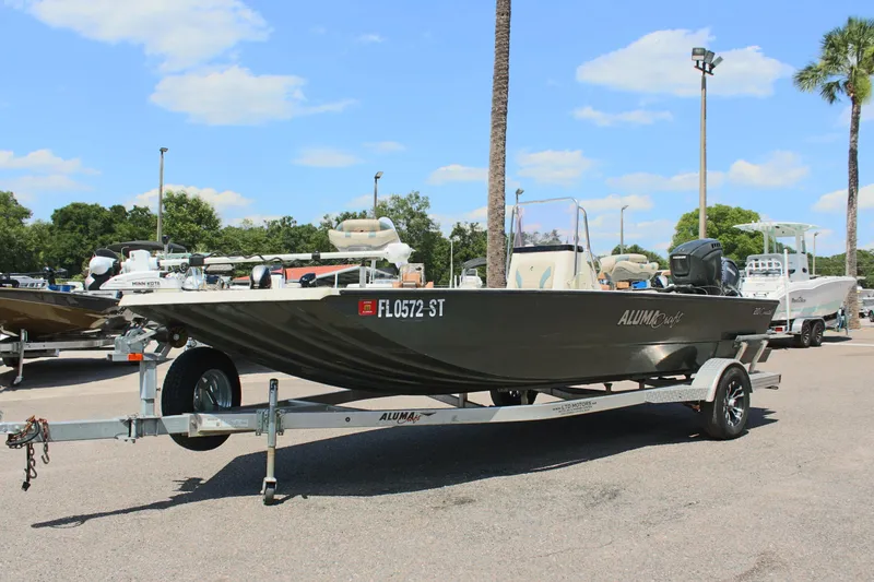 Slide: The Image of 2020 Alumacraft 20 Coastal Bay boat on trailer in sunny outdoor setting. - 2