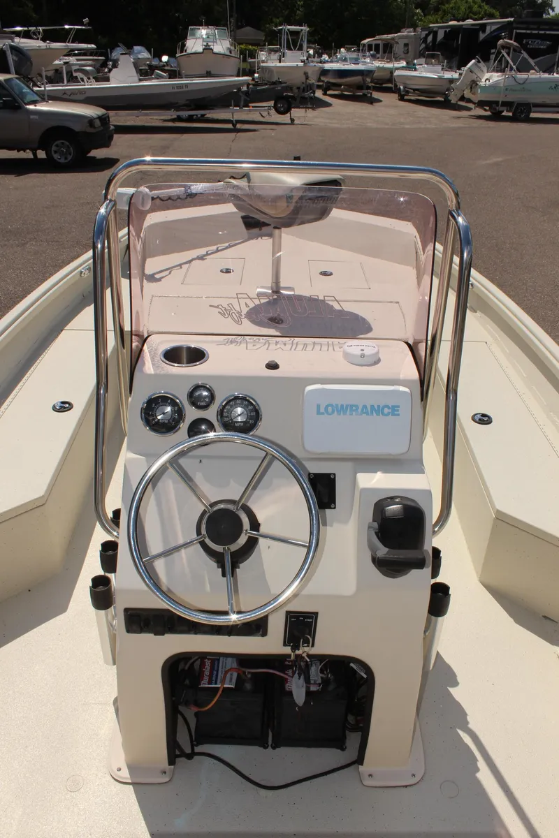 Slide: The Image of 2020 Alumacraft 20 Coastal Bay boat console with steering wheel and navigation equipment. - 21