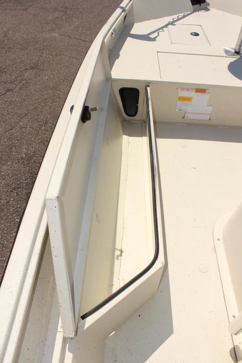 Slide: The Image of 2020 Alumacraft 20 Coastal Bay boat storage compartment, open and empty. - 29