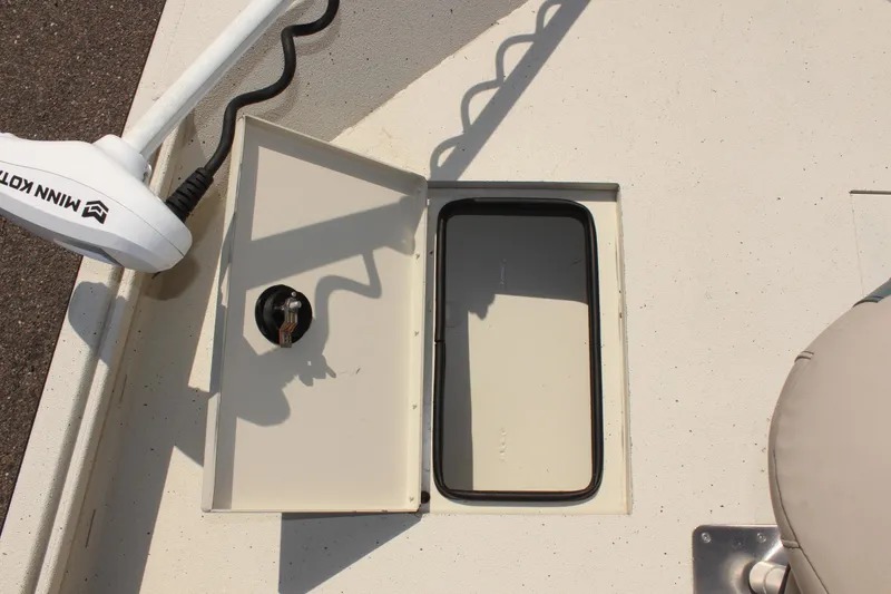 Slide: The Image of 2020 Alumacraft 20 Coastal Bay boat storage compartment with Minn Kota trolling motor. - 36