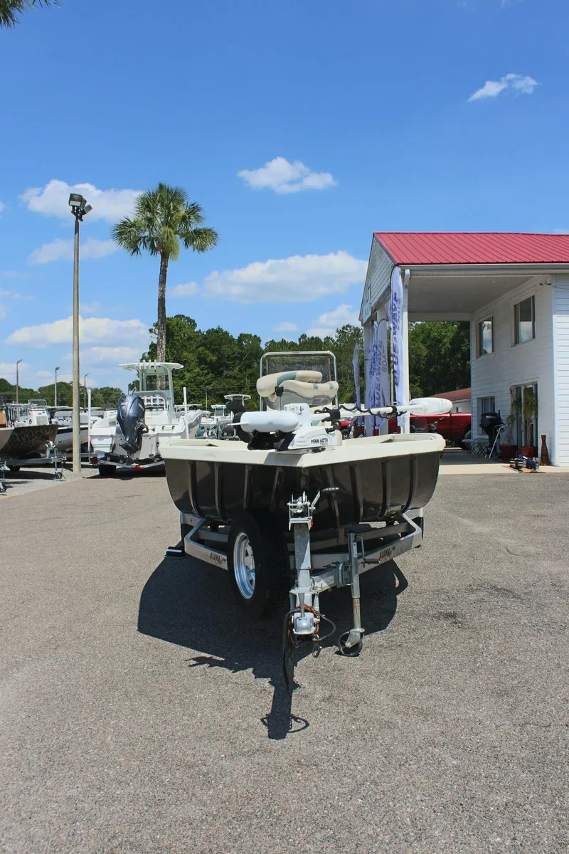 Slide: The Image of 2020 Alumacraft 20 Coastal Bay boat on trailer, parked outdoors under blue sky. - 5