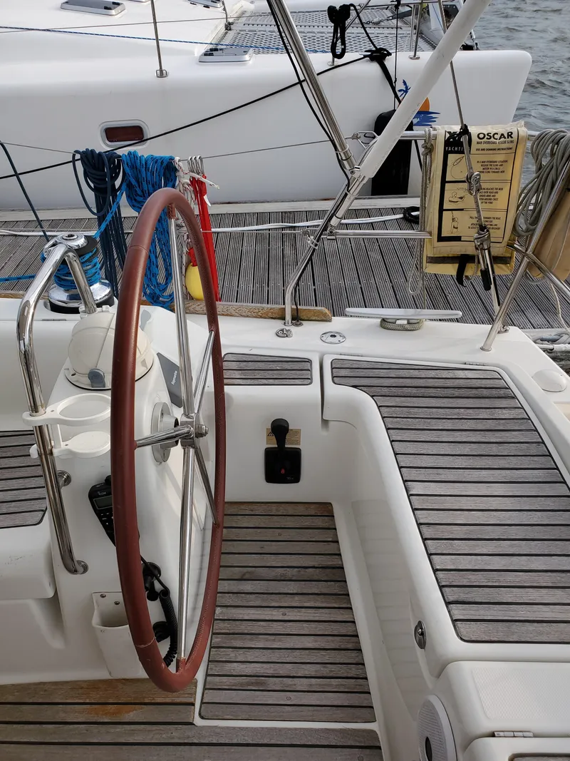 Slide: The Image of Beneteau 43 sailboat cockpit, 2008 model, featuring a wooden steering wheel and deck. - 11