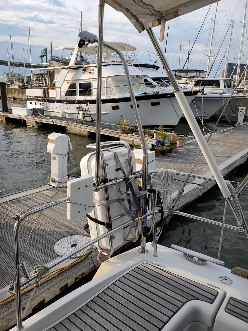 Slide: The Image of Beneteau 43 sailboat docked at marina, 2008 model, with nearby yachts and clear sky. - 19