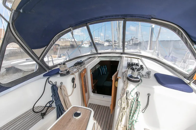 Slide: The Image of Beneteau 43 sailboat cockpit, 2008 model, with ropes and open cabin view. - 23