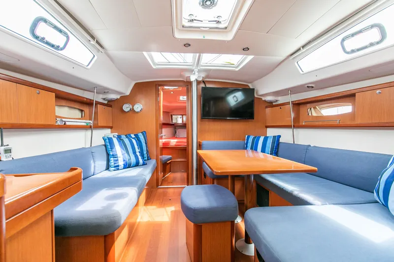 Slide: The Image of Interior of 2008 Beneteau 43 yacht with blue seating and wooden accents. - 33