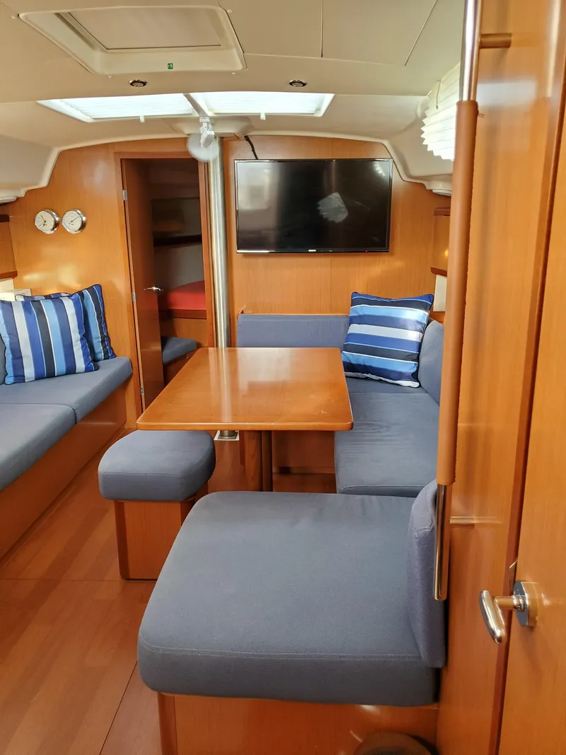 Slide: The Image of Interior of 2008 Beneteau 43 sailboat with cozy seating and wooden table. - 36