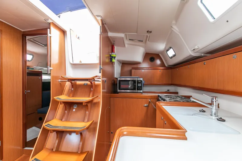 Slide: The Image of Interior of 2008 Beneteau 43 yacht with modern kitchen and wooden cabinetry. - 39