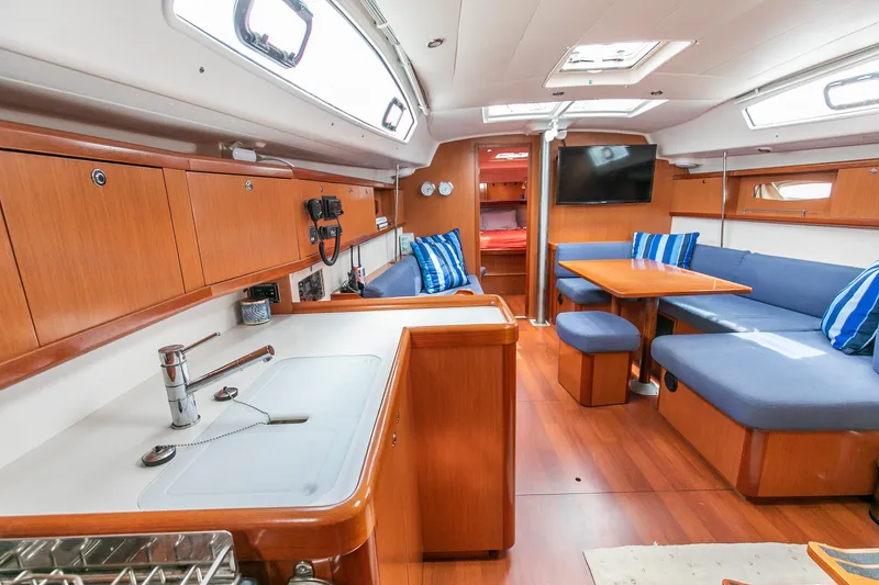 Slide: The Image of Interior of 2008 Beneteau 43 yacht with modern kitchen and cozy seating area. - 43
