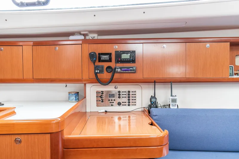 Slide: The Image of Interior of 2008 Beneteau 43 sailboat with navigation equipment and wooden cabinetry. - 45