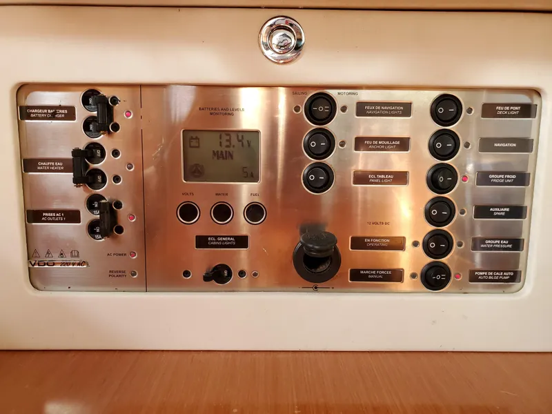 Slide: The Image of Control panel of a 2008 Beneteau 43 yacht, featuring various switches and a digital display. - 48