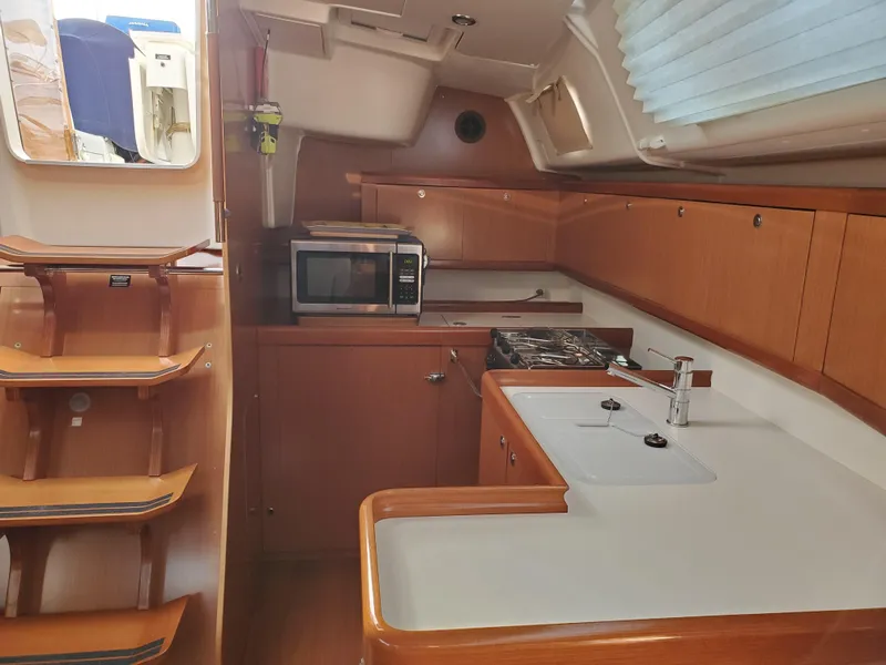 Slide: The Image of Interior of 2008 Beneteau 43 yacht kitchen with wood cabinetry and modern appliances. - 49