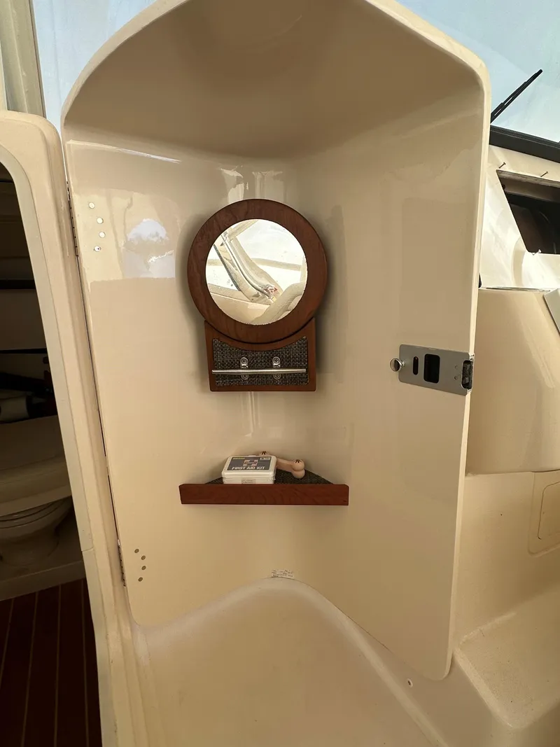 Slide: The Image of 2022 Grady-White Freedom 325 boat interior with mirror and shelf. - 15
