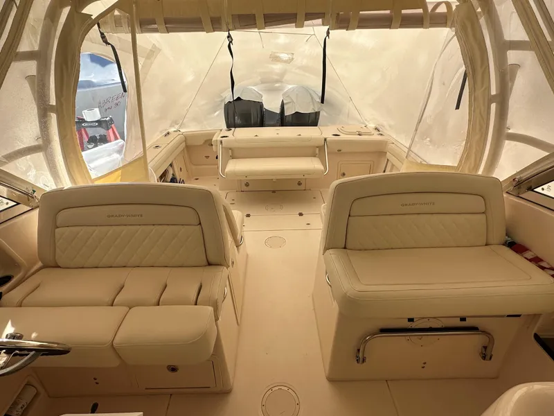 Slide: The Image of Interior of 2022 Grady-White Freedom 325 boat with beige seating and canopy. - 4