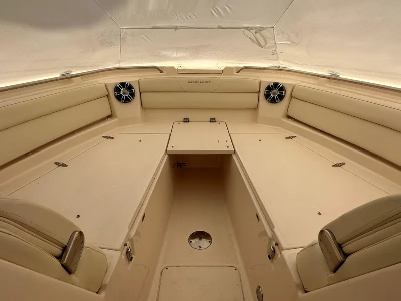Slide: The Image of 2022 Grady-White Freedom 325 boat interior with beige seating and speakers. - 6