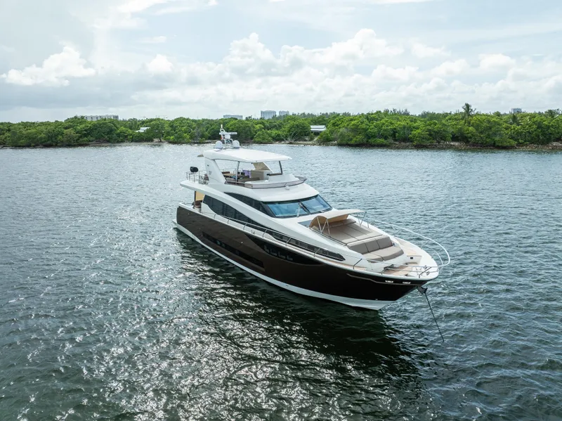 Slide: The Image of Luxury 2015 Prestige 750 yacht cruising on serene waters. - 0