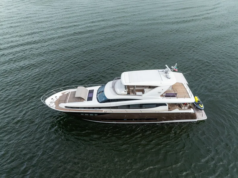 Slide: The Image of Prestige 750 yacht, 2015 model, cruising on calm waters. - 12