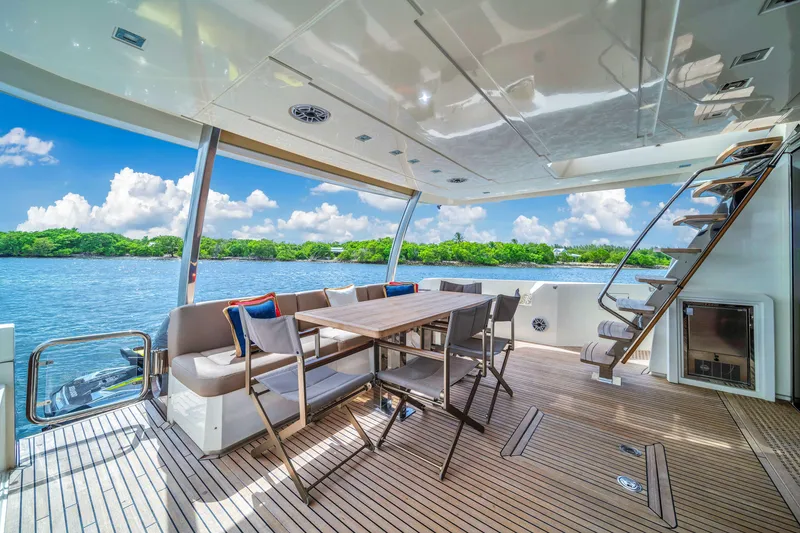Slide: The Image of Luxurious 2015 Prestige 750 yacht deck with dining area and scenic water view. - 17