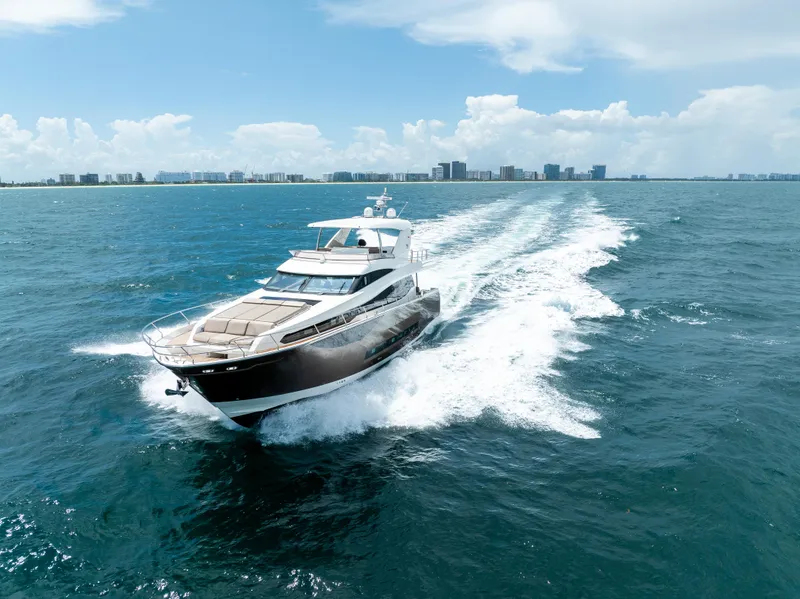 Slide: The Image of Prestige 750 yacht cruising on open sea, 2015 model, under clear blue skies. - 2