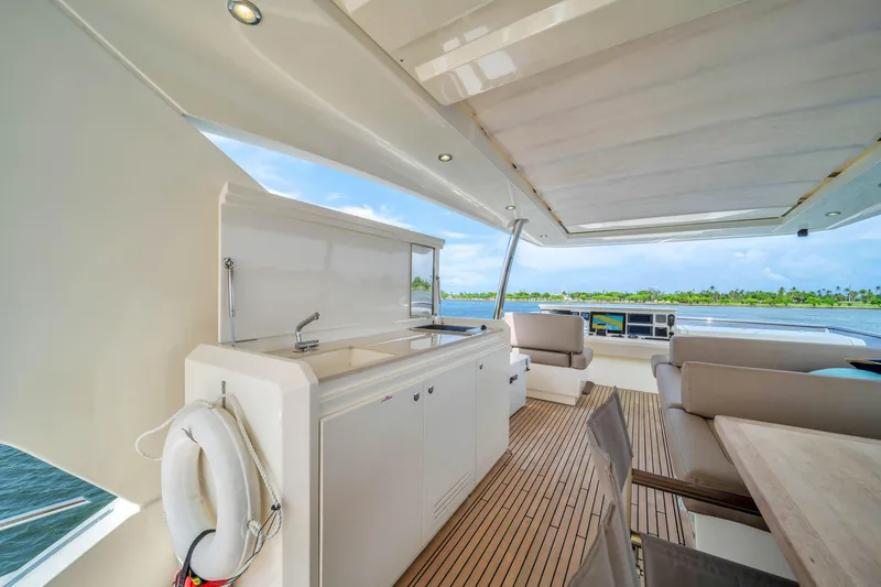 Slide: The Image of Luxurious 2015 Prestige 750 yacht deck with outdoor kitchen and seating area. - 30