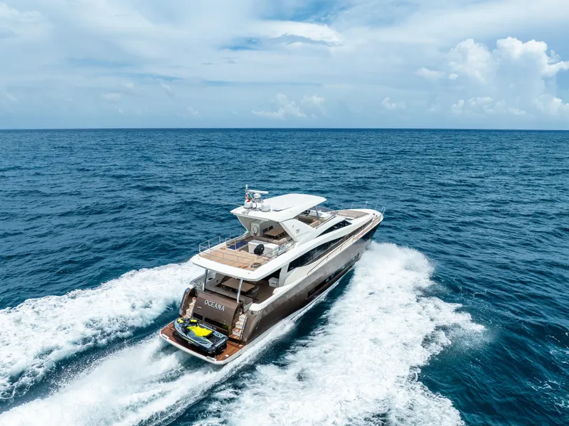 Slide: The Image of Prestige 750 yacht cruising on open sea, 2015 model, under clear blue sky. - 4