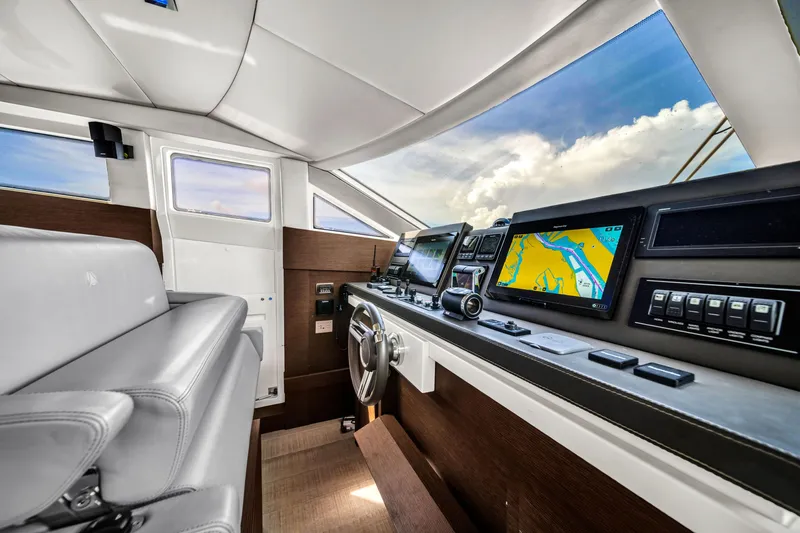 Slide: The Image of Luxurious 2015 Prestige 750 yacht cockpit with modern navigation equipment and plush seating. - 45