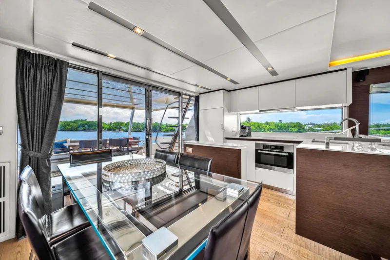 Slide: The Image of Luxurious interior of 2015 Prestige 750 yacht with modern kitchen and dining area. - 49