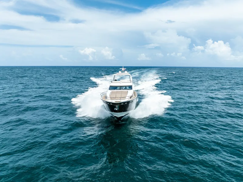 Slide: The Image of Prestige 750 yacht cruising on open sea, 2015 model, under clear blue sky. - 8
