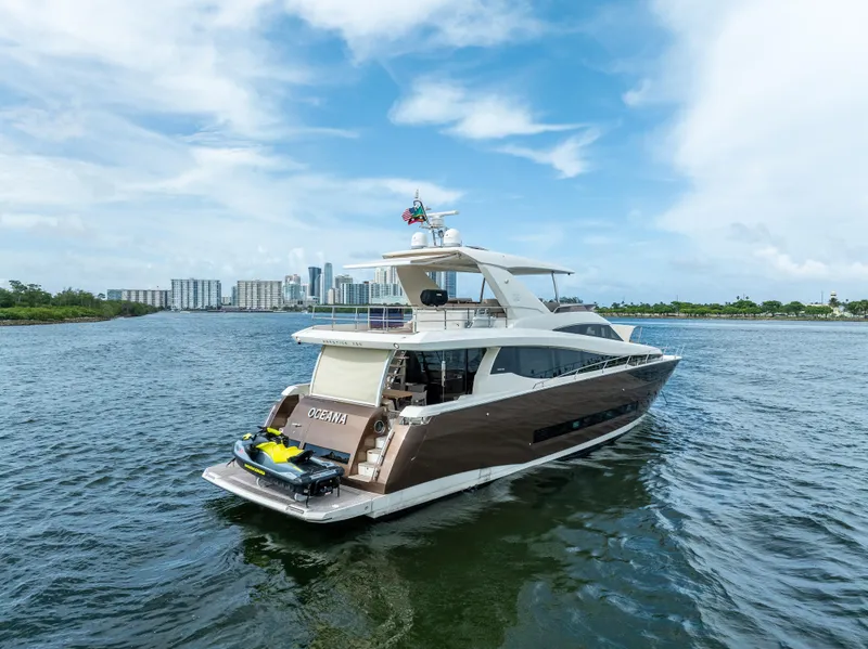 Slide: The Image of Luxury 2015 Prestige 750 yacht cruising on a scenic waterway. - 9