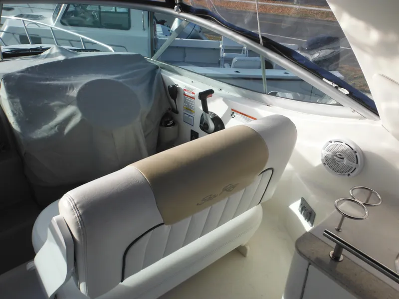 Slide: The Image of 2010 Sea Ray 260 Sundancer cockpit with helm, seating, and controls. - 10