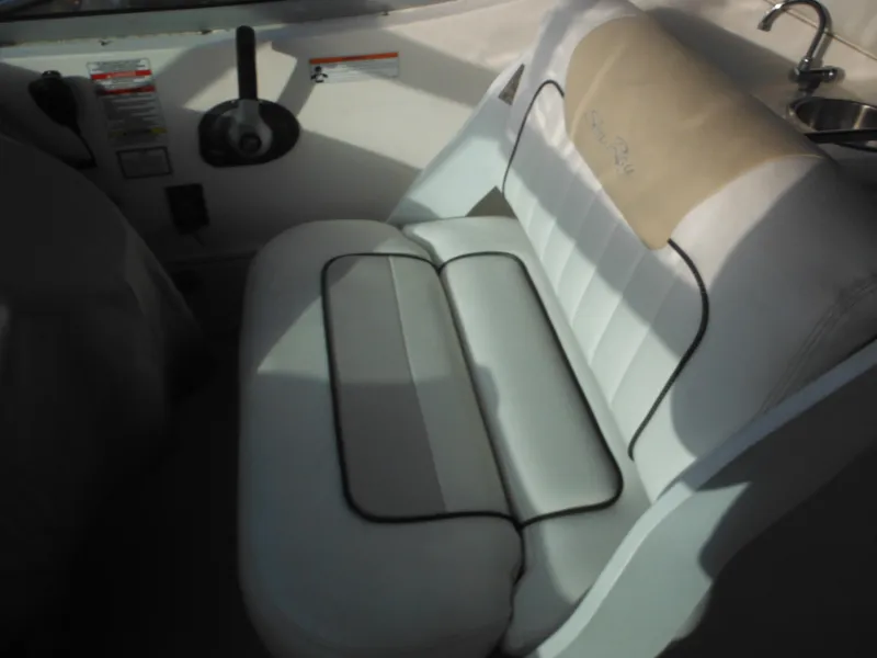 Slide: The Image of 2010 Sea Ray 260 Sundancer boat interior seating and controls. - 11