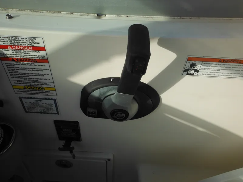 Slide: The Image of Throttle control of 2010 Sea Ray 260 Sundancer boat with safety warnings. - 13