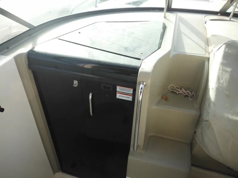 Slide: The Image of 2010 Sea Ray 260 Sundancer interior with compact kitchenette and seating area. - 20
