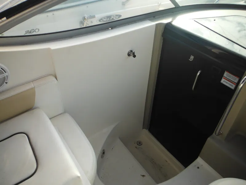 Slide: The Image of Interior of 2010 Sea Ray 260 Sundancer boat, featuring seating and storage area. - 21