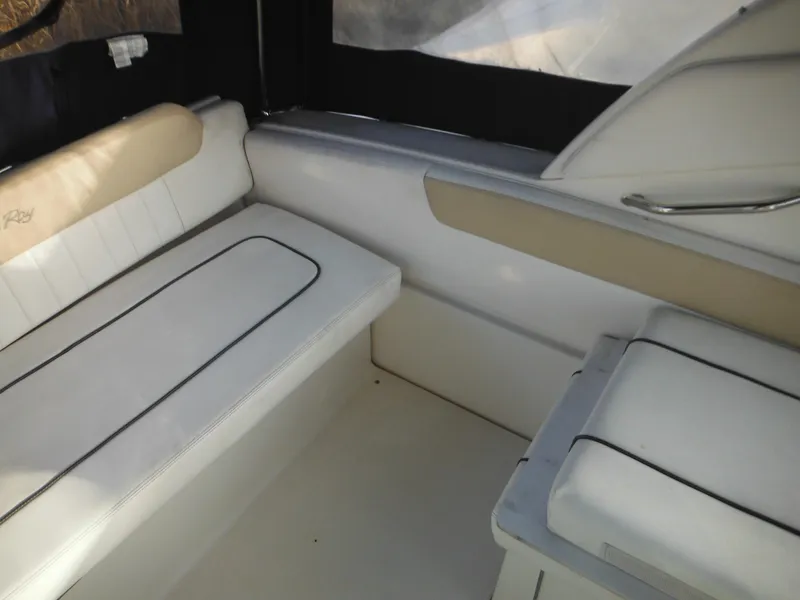 Slide: The Image of Interior seating of 2010 Sea Ray 260 Sundancer boat, featuring white and beige upholstery. - 23