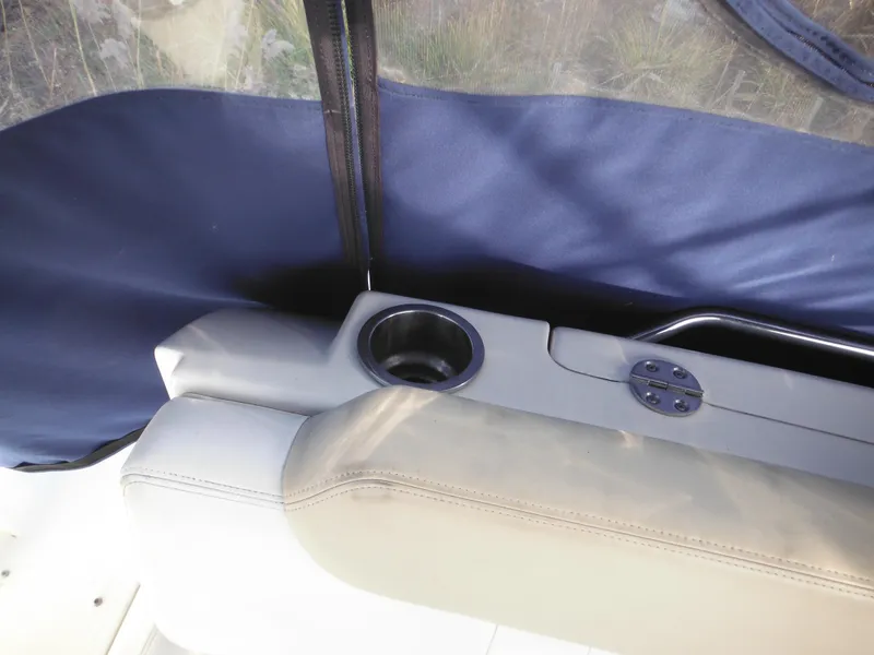 Slide: The Image of Sea Ray 260 Sundancer 2010 boat interior with cup holder and blue cover. - 26